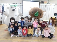 写真:エコクマと一緒に写真撮影する2歳児