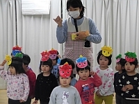 写真:鬼のお面を紹介する2歳児