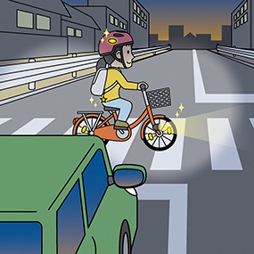画像:ライトを点灯する自転車