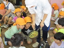 鍋をのぞき込む子どもの写真