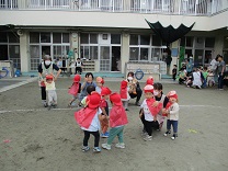 アンパンマンの扮装で体操をする1歳児の写真