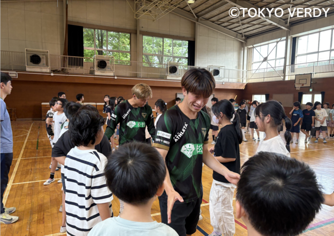 写真：選手が子どもたちとハイタッチをする様子