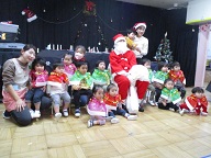 ひよこぐみがサンタさんと写真を撮っています