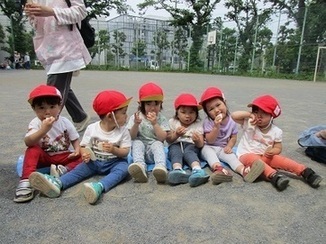 子ども達が児童館で遠足のおやつを食べている写真