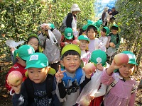 とったリンゴを見せている様子の写真