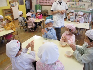 5歳児の子ども達がおにぎりを作っている様子の写真