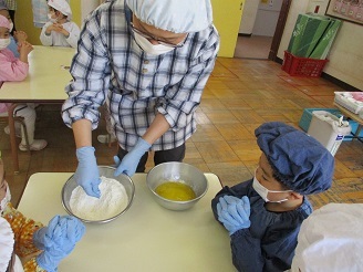 5歳児らいおん組がクッキー作りの材料を見せてもらっている様子の写真