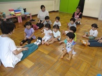 手で膝を叩く2歳児の写真